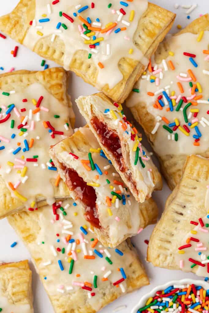 homemade pop tart cut in half next to a bunch of pop tarts