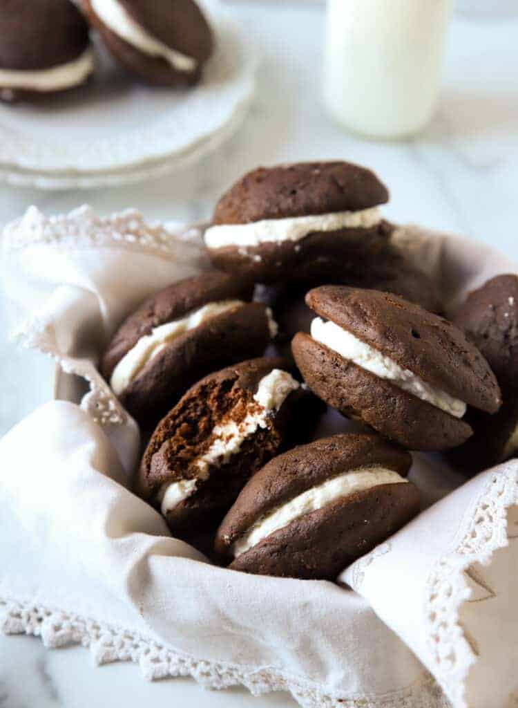 several whoopie pies in a bowl lined with a linen napkin