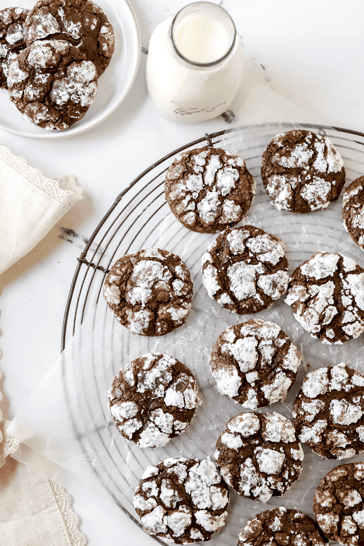 double chocolate crinkle cookies rolled in powdered sugar on a wire rack