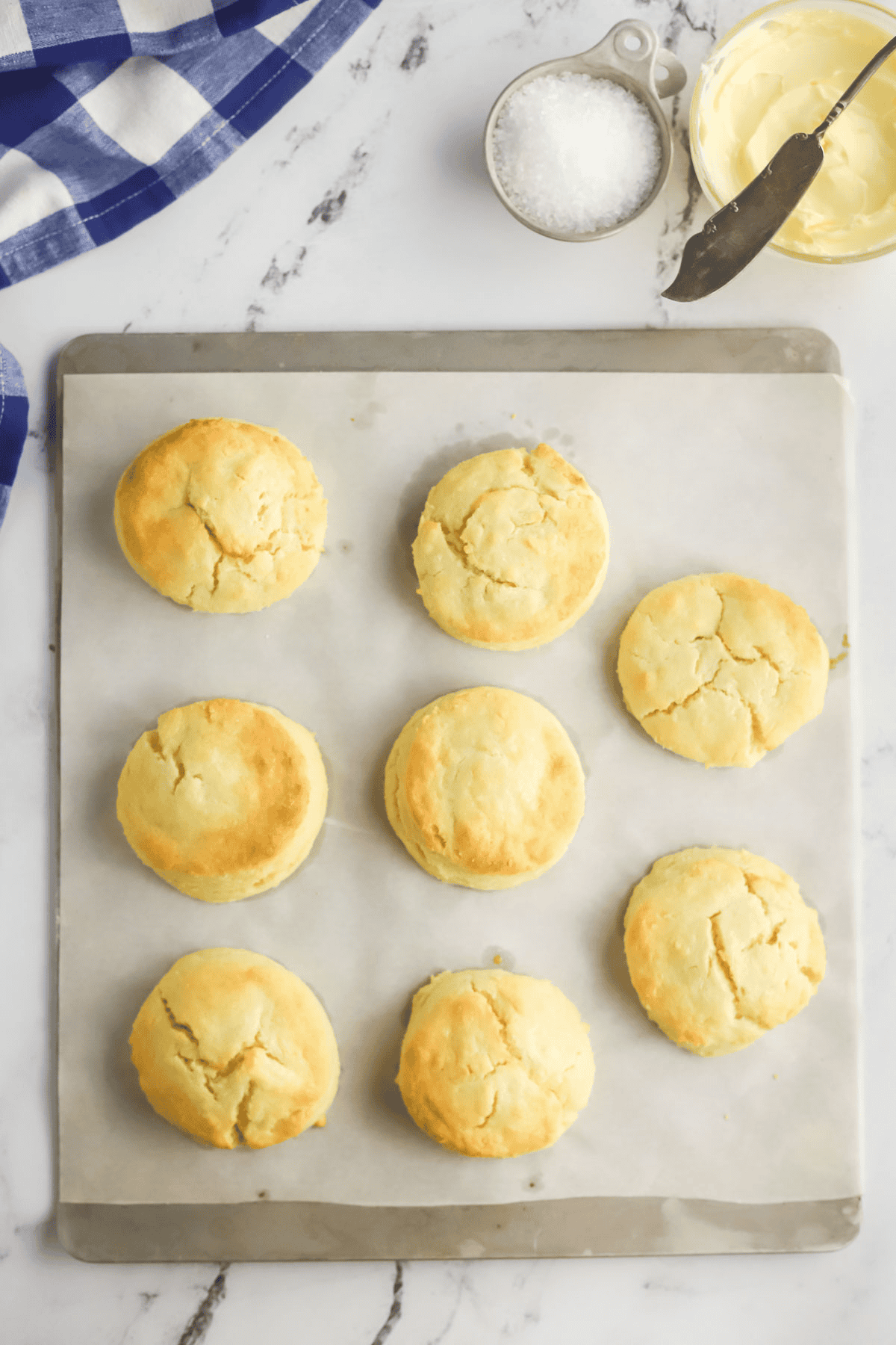 baked biscuits on a parchment lined baking sheet