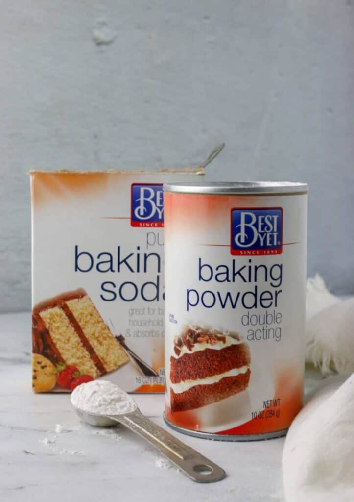a can of baking powder and a carton of baking soda