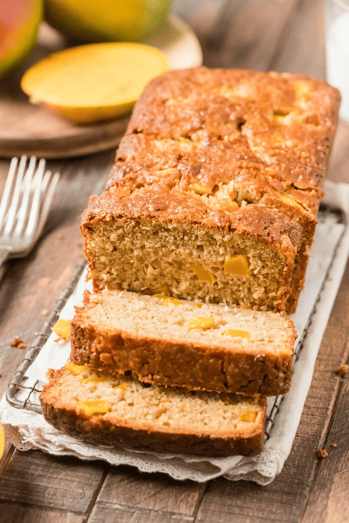 mango quick bread sliced on a wire rack