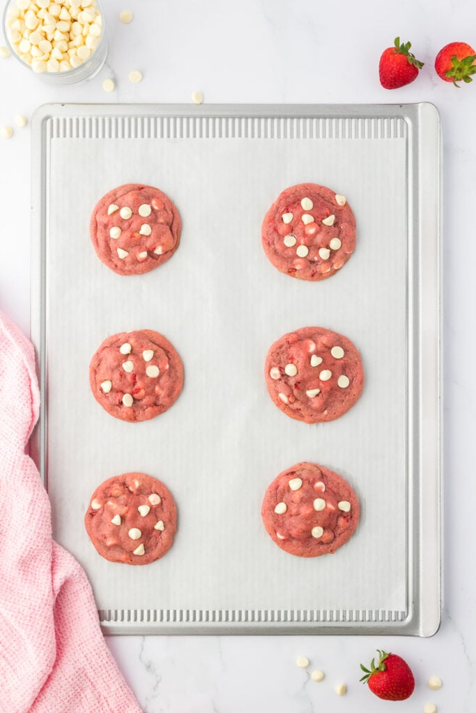 six baked strawberry cheesecake cookies on a cookie sheet
