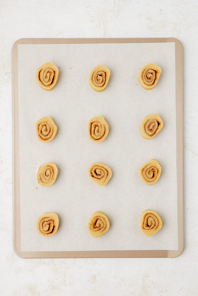 unbaked cinnamon roll cookies on a cookie sheet