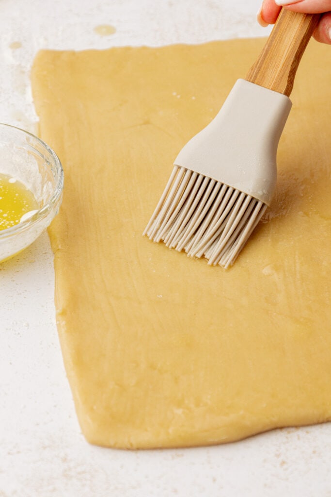 butter being spread onto cookie dough