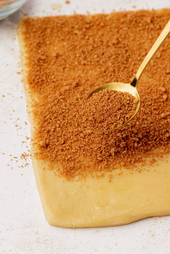 cinnamon sugar mixture sprinkled onto cookie dough