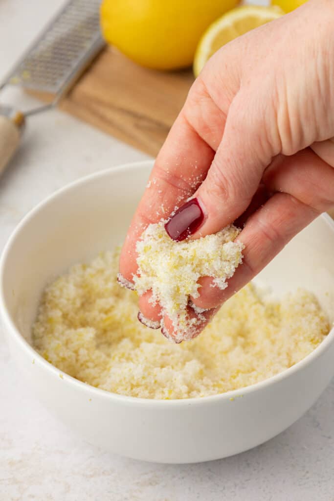 hand rubbing lemon zest into sugar