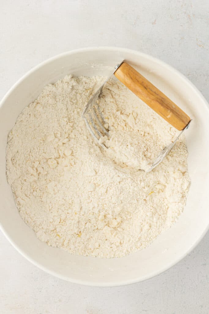 pastry cutter cutting butter in bowl