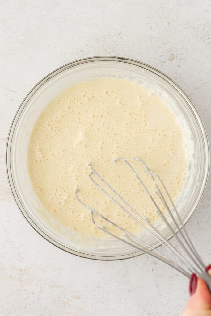 scone wet ingredients in a bowl with a whisk