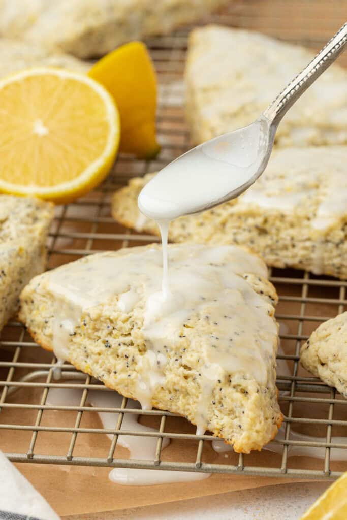 lemon icing drizzled over lemon poppyseed scone
