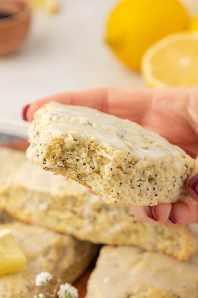 hand holding a lemon poppyseed scone
