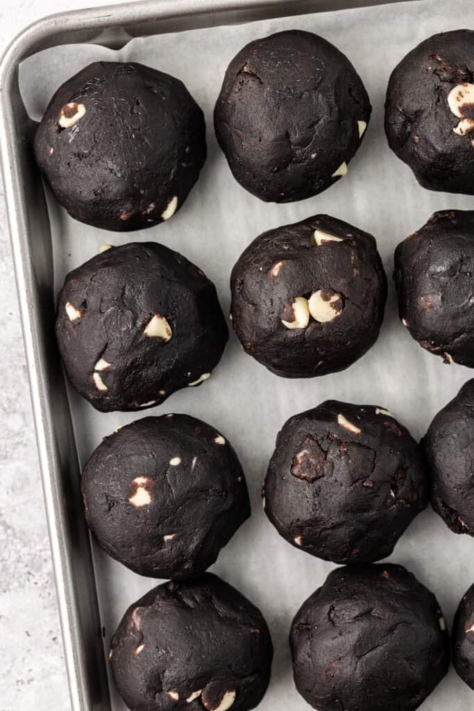 cookie dough balls on a cookie sheet
