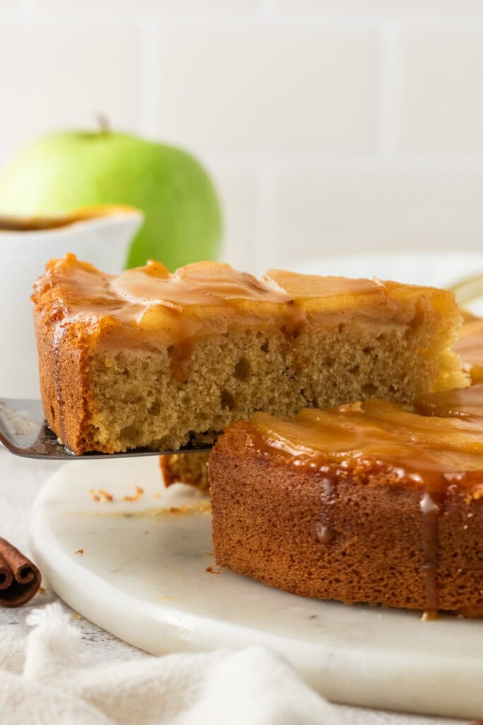 apple upside down cake on a cake server
