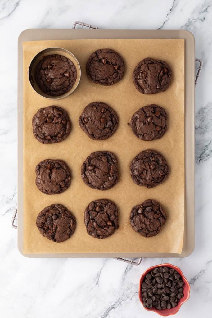 baked double chocolate chip cookies on a cookie sheet