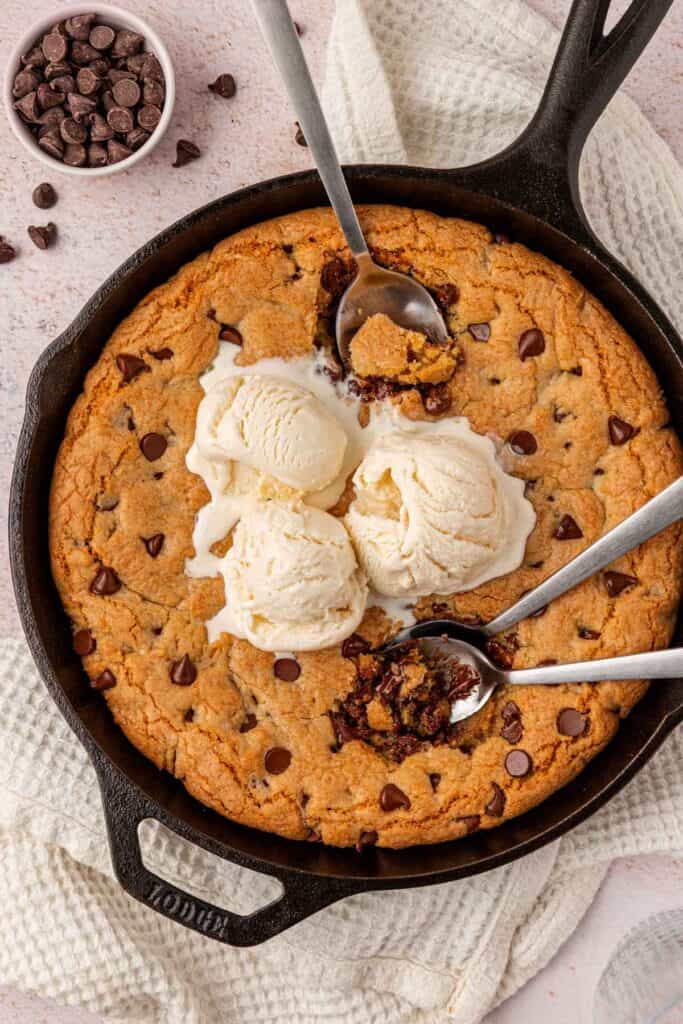 pizookie toppd with icecream and spoons dug into it