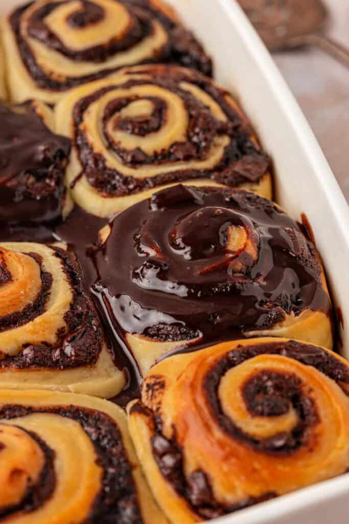 chocolate glaze spread over the top of the rolls