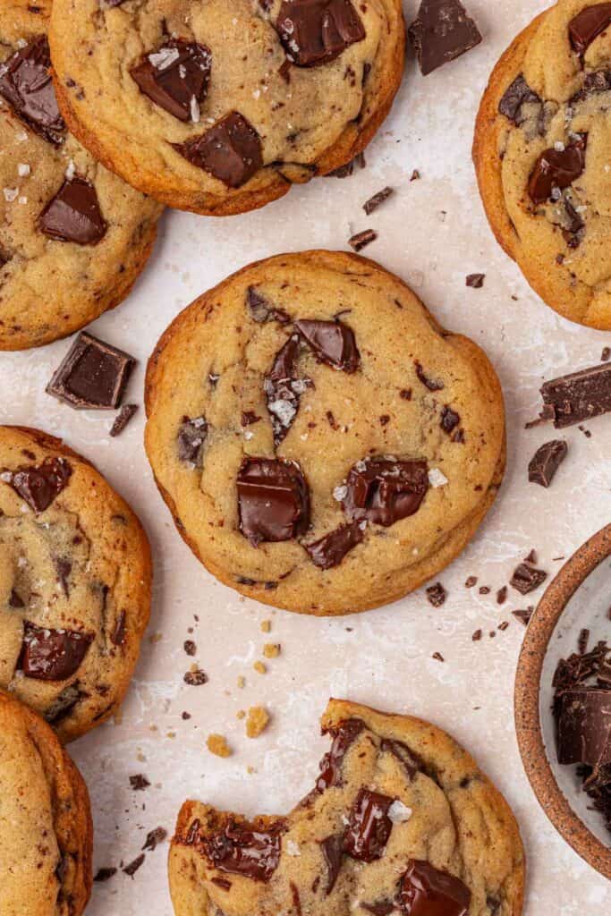 a bunch of bakery style chocolate chip cookies next to each other