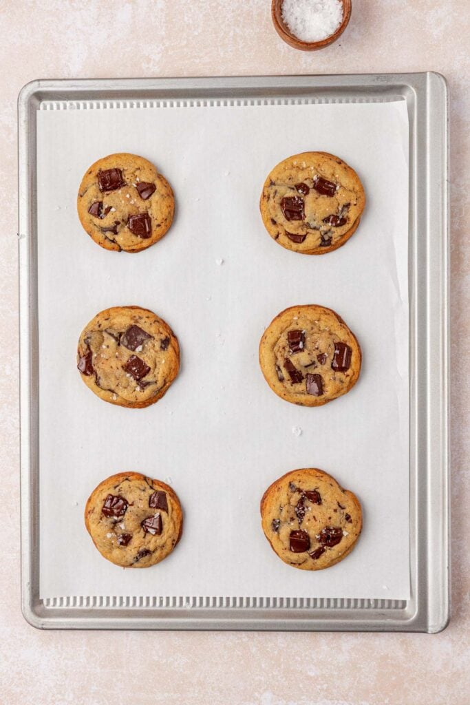 six baked bakery style chocolate chip cookies