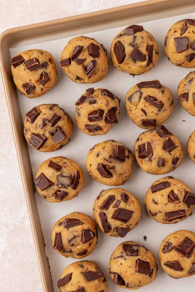 cookie dough balls on a cookie sheet