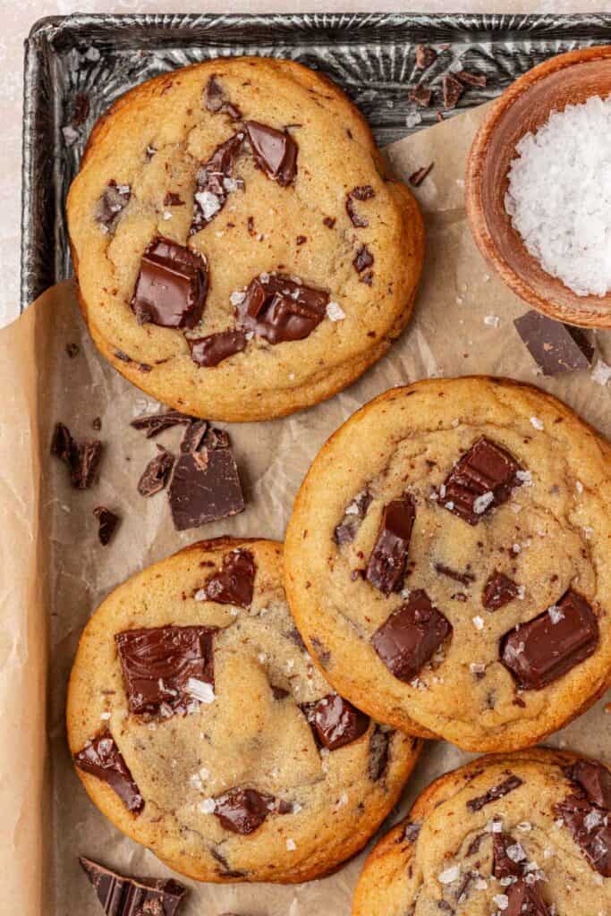 a few baked bakery style chocolate chip cookies on a cookie sheet